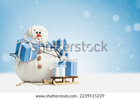happy snowman with gifts on light blue background