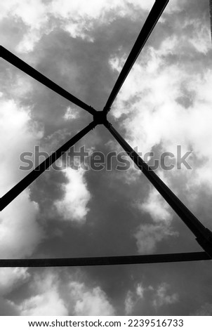 Selective focus. Black and white photography. Sky on top of a mountain. Geodetic triangulation sign.