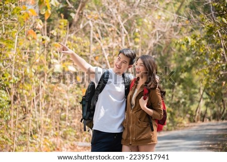 Asian couple lover, smart male and beautiful female trekking and hiker in holiday together, Active young tourists relaxing in holiday, couple traveling summer adventure journey in nature outdoors.

