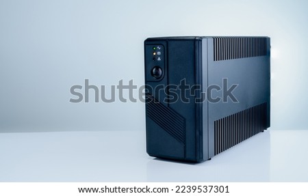 Uninterruptible power supply on white background. Backup Power UPS with battery. UPS with stabilizer for home PC. UPS inverter. Equipment for computer system at office for security. Power protection. Royalty-Free Stock Photo #2239537301