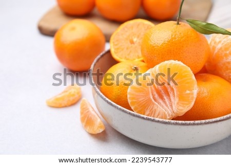 Fresh juicy tangerines on light grey table, closeup. Space for text Royalty-Free Stock Photo #2239543777