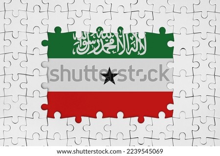 Somaliland flag in frame of white puzzle pieces with missing central parts