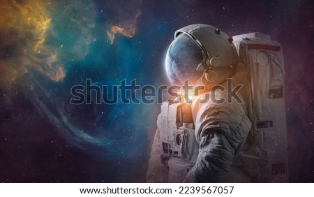 Astronaut in deep space. Science space art. Creative surreal wallpaper. Spaceman in bright galaxy. Elements of this image furnished by NASA Royalty-Free Stock Photo #2239567057
