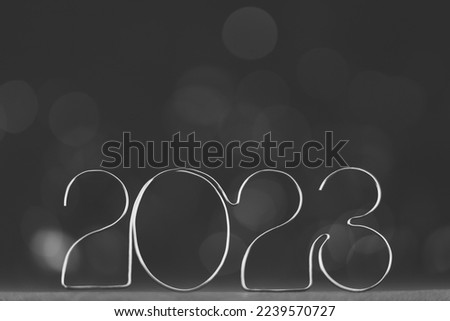 Happy New Year 2023. Beautiful black and white web banner or billboard template with silver number 2023 on gray background with copy space for text High quality photo
