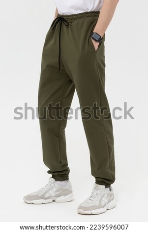 Man in blank green jogger pants mock-up Royalty-Free Stock Photo #2239596007