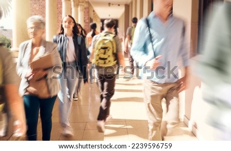 University, campus and busy students walking to class for learning, studying and education. College, crowd and group of people, men and women at school in hallway or corridor traveling to classroom.