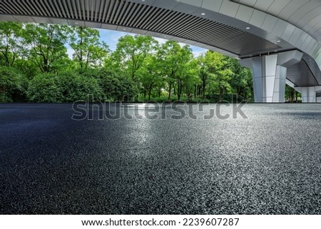 Asphalt road and bridge with green tree background