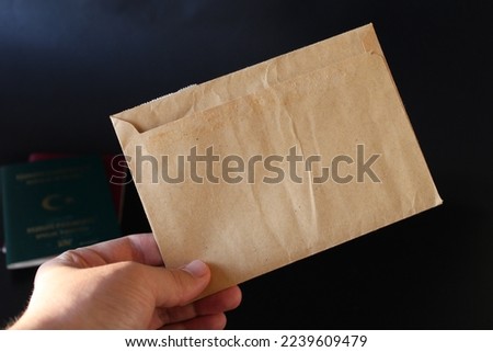 yellow envelope in man's hand