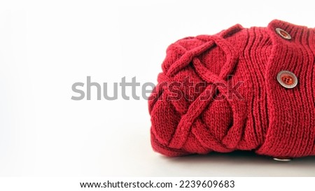 crimson wool knitted sweater with pigtail pattern, isolated on white background, copy space

