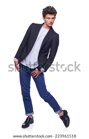 Full body of a fashion man with modern haircut posing over white background