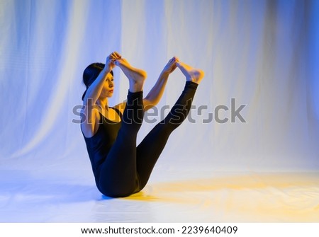 athletic woman doing pilates exercises, toning exercises for the press, crunches to strengthen the stomach, in sportswear in a yoga studio or at home