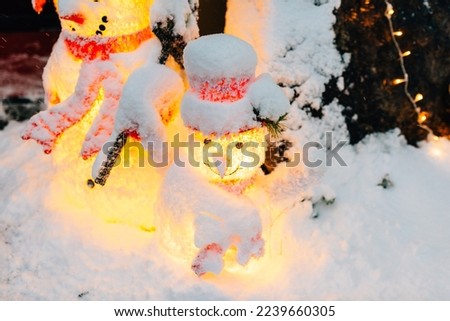 Snowman covered in snow at Christmas