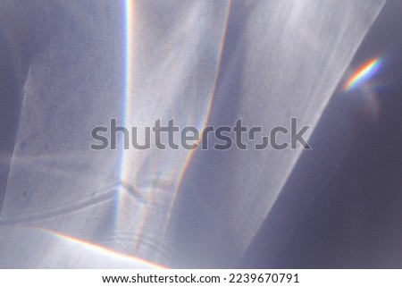 Sunlight background, abstract photo with light and shadow, glare and shine on paper texture, rainbow flare from sun, gray blue monochrome minimal aesthetic fon. Natural light and caustic effects. Royalty-Free Stock Photo #2239670791