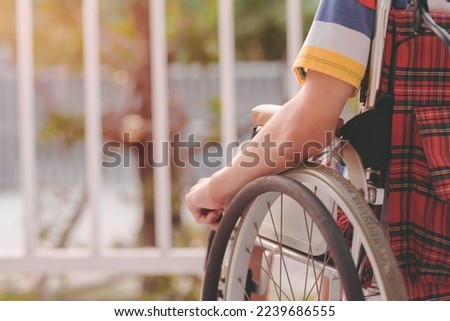Arm of young man with disability sitting look at the sun on nature background on balcony of home or hospital,school,nursery with sunlight at sunset Positive photography and Good mental health concept.