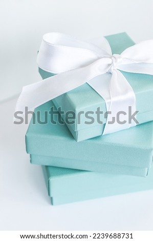 Jewelry boxes piled on top of each other with silk ribbon.
