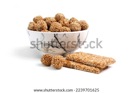  special Sesame seed ball called Till ke laddu in bowl isolated on white background happy makar sankranti Royalty-Free Stock Photo #2239701625