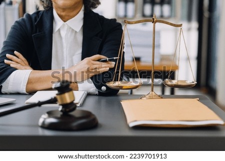 law books and scales of justice on desk in library of law firm. jurisprudence legal education concept. Royalty-Free Stock Photo #2239701913