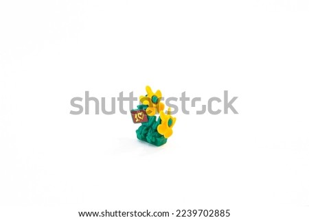 a toy figure flowers a clearing helicopters an isolated object on a white background.