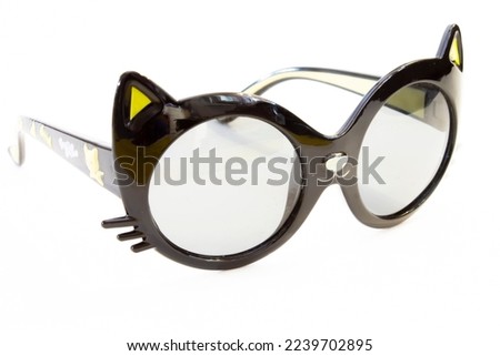 black children's sunglasses shaped like cats with ears on a white background isolated object.