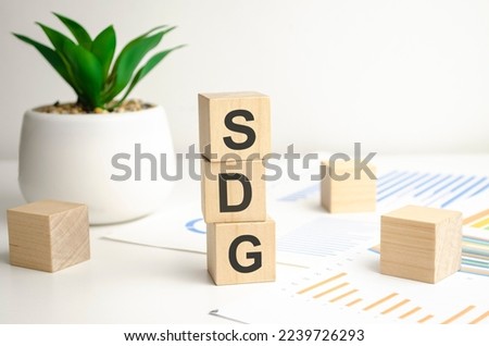 word SDG is made of wooden blocks on white background Royalty-Free Stock Photo #2239726293