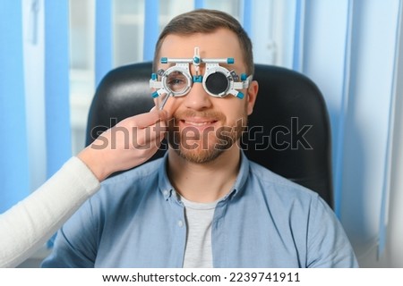 Handsome young man is checking the eye vision in modern ophthalmology clinic. Patient in ophthalmology clinic. Royalty-Free Stock Photo #2239741911