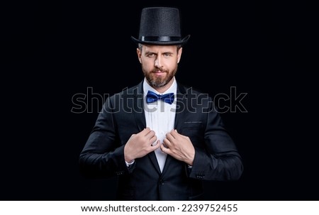 caucasian tuxedo showman in studio. tuxedo showman with cylinder hat. photo of tuxedo showman