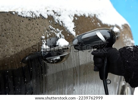 Defrosting a car lock with a hair dryer