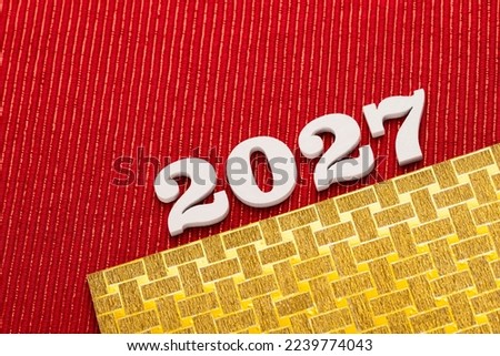 Happy new year 2027 - White wooden letters on red background