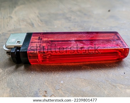 portrait of a used red lighter