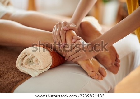 Woman getting relaxing feet massage with oils after long day Royalty-Free Stock Photo #2239821133
