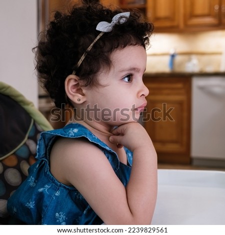Cute two year old baby girl portrait in a home setting.