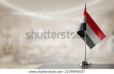 A small Yemen flag on an abstract blurry background Royalty-Free Stock Photo #2239840637