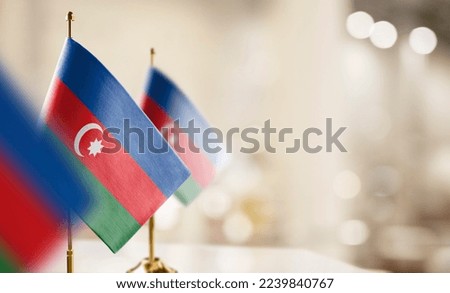 Small flags of the Azerbaijan on an abstract blurry background Royalty-Free Stock Photo #2239840767