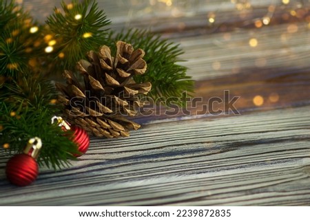 Christmas background with red Christmas tree decorations on a dark wooden board