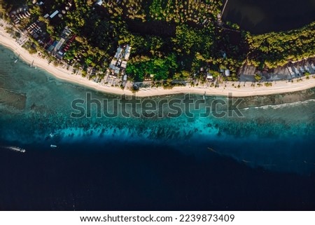 Tropical beach and transparent ocean with boats, aerial view. Tropical Gili islands in Indonesia