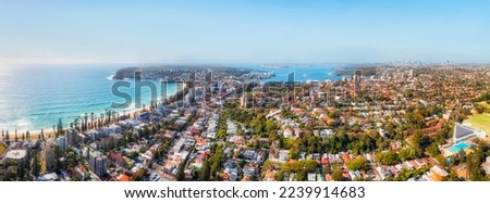 Elevated aerial panorama over wealthy famous Manly beach suburb on Sydney Northern beaches - scenic cityscape.