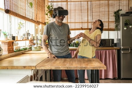 mature married couples play with virtual reality in the kitchen Royalty-Free Stock Photo #2239916027