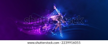 Young muscular athlete, runner or jogger posing over blue background neon elements. Concept of sport, healthy lifestyle, motion. Concept of sport, healthy lifestyle, motion. Copy space for ad.