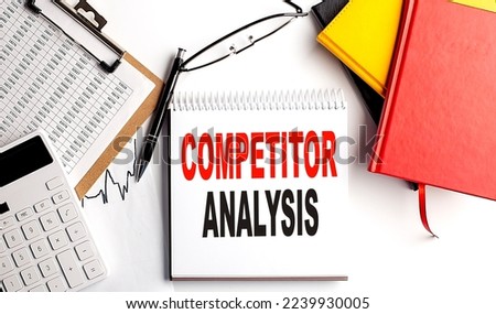 COMPETITOR ANALYSIS text on notebook with clipboard and calculator on a white background