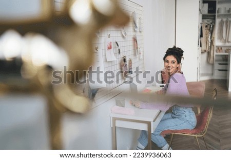 Young millennial woman freelancer work remote at home sitting at table with laptop computer device. Female student learning online with webinar course while using portable netbook for distantly study