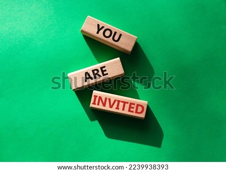 You are invited symbol. Wooden blocks with words You are invited. Beautiful green background. Business and You are invited concept. Copy space.