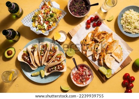 Mexican Sharing Food with Tacos, Nachos and Black beans