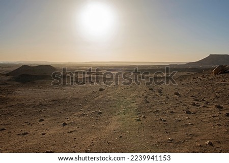 Landscape scenic view of desolate barren rocky western desert in Egypt with mountains at sunrise Royalty-Free Stock Photo #2239941153