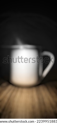 Defocused abstract background of a cup made of porcelain in the dark place