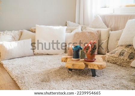 Bohemian style interior with beautiful light colours like beige and off-white and a lot of pillows