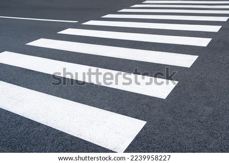 Freshly painted crosswalk. Asphalt marked on the road. new pedestrian zebra background in the city street Royalty-Free Stock Photo #2239958227
