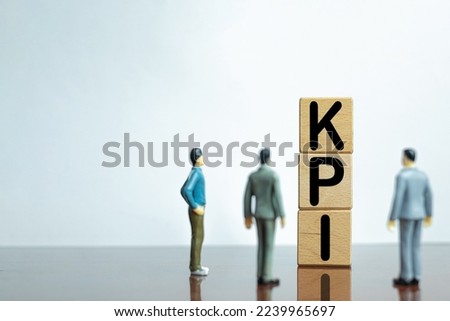 KPI,Key Performance Indicator for target achievement,planning concept.,Three Businessman looking wooden cube with KPI word over white background with copyspace.business idea. Royalty-Free Stock Photo #2239965697