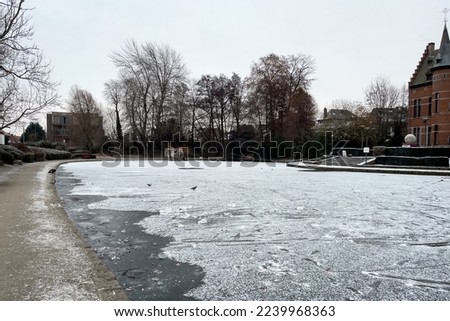 Frosted pond next to Brasserie Mariadal building in Zaventem, Belgium Royalty-Free Stock Photo #2239968363