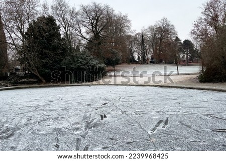 Frosted pond next to Brasserie Mariadal building in Zaventem, Belgium Royalty-Free Stock Photo #2239968425