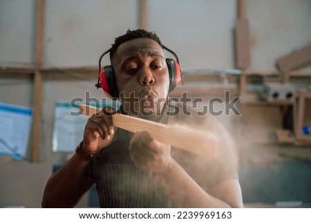 Young African carpenter wood working in factory Royalty-Free Stock Photo #2239969163